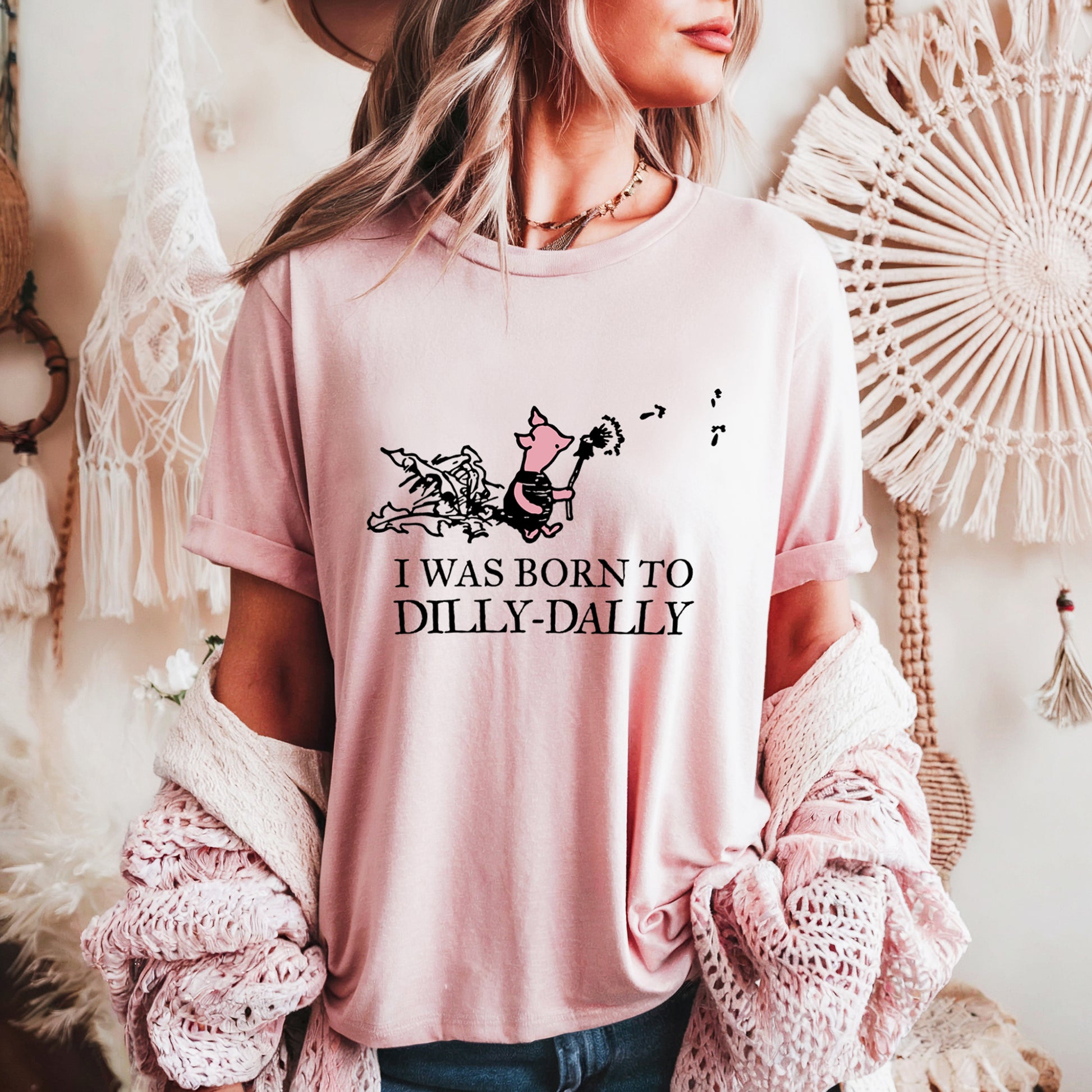 women's t-shirt featuring Piglet blowing dandelion seeds with text: I Was Born To Dilly-Dally; graphic tee; Winnie the Pooh apparel; funny tshirt; online tshirt store; bella canvas 3001 light pink
