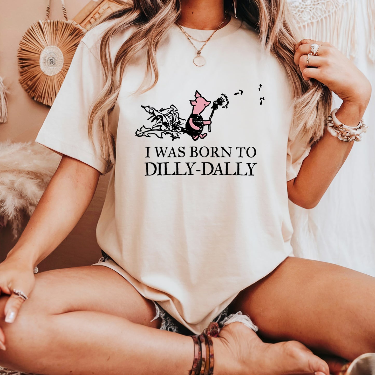 women's t-shirt featuring Piglet blowing dandelion seeds with text: I Was Born To Dilly-Dally; graphic tee; Winnie the Pooh apparel; funny tshirt; online tshirt store; bella canvas 3001 natural