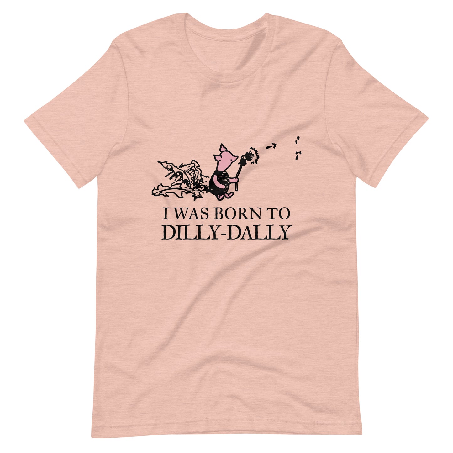 women's t-shirt featuring Piglet blowing dandelion seeds with text: I Was Born To Dilly-Dally; graphic tee; Winnie the Pooh apparel; funny tshirt; online tshirt store; bella canvas 3001 heather prism peach